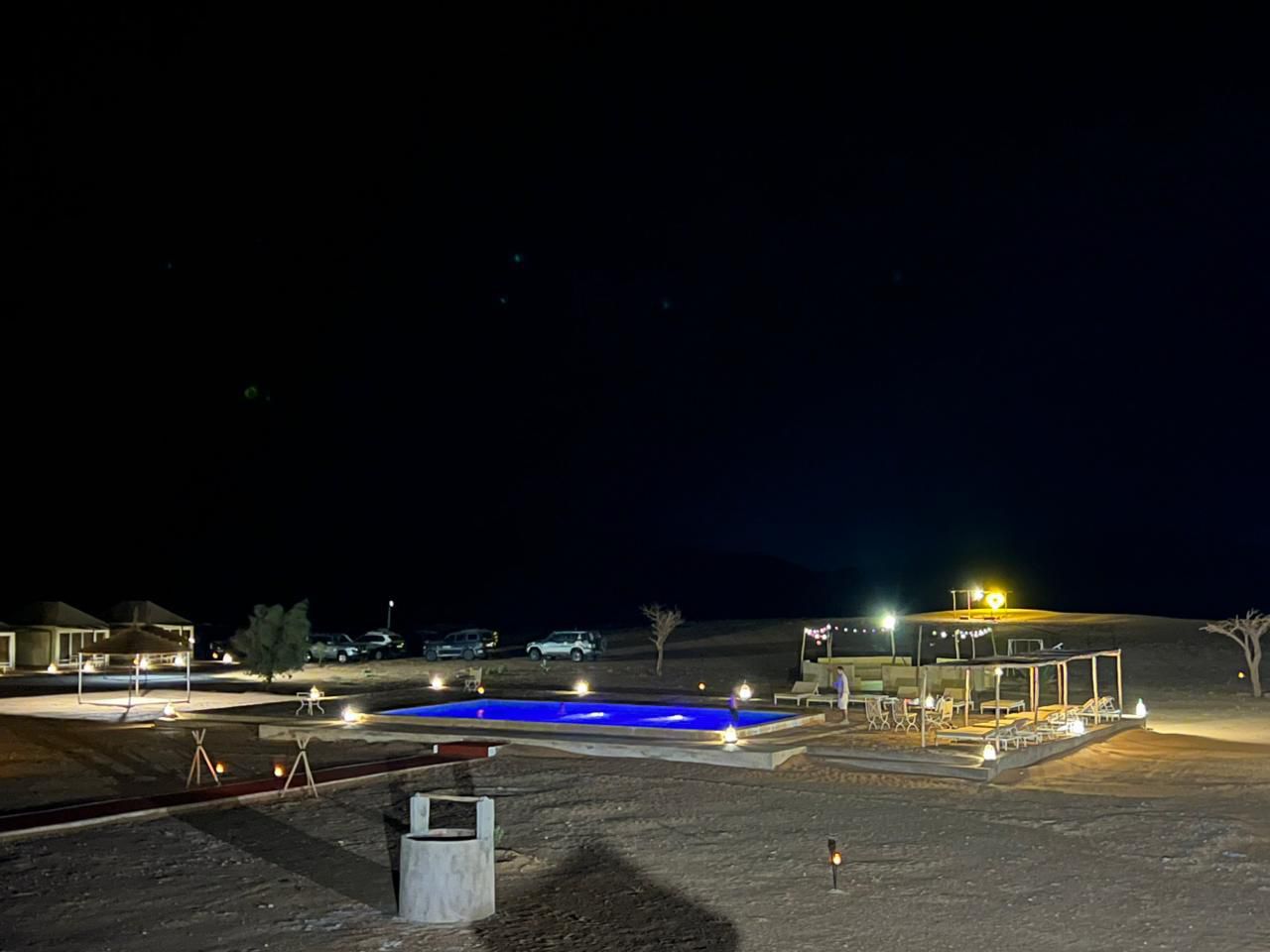 Milky Way over the pool at Sahara Royal Resort – luxury desert camp Merzouga Morocco